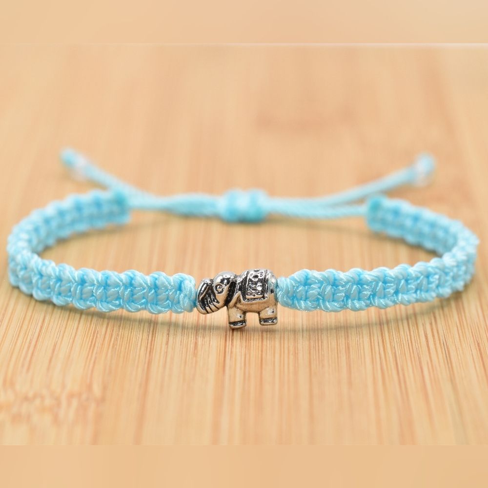 Handmade baby blue string bracelet with an elephant charm